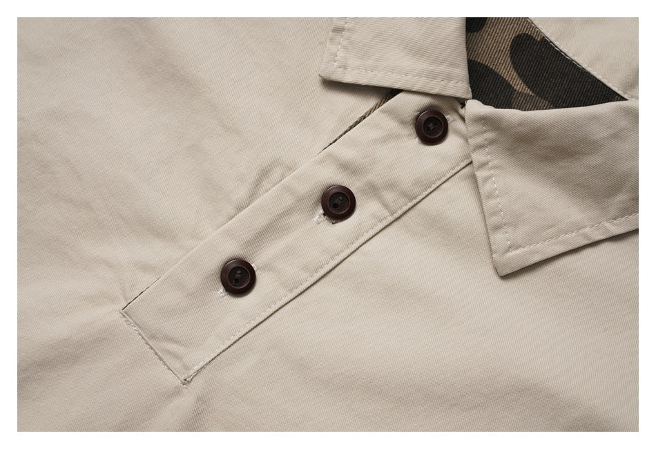 Close-up of the beige jacket's angled placket with three dark buttons and camouflage-print collar facing.