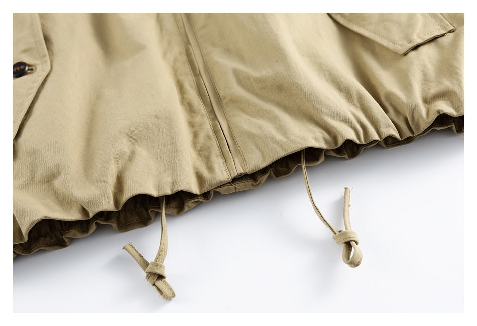 Close-up of the khaki jacket's gathered hem with adjustable drawcords.