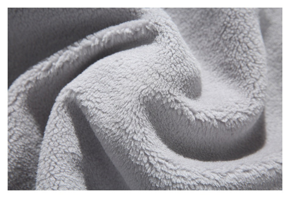 Close-up of light gray plush fleece gathered into soft folds.