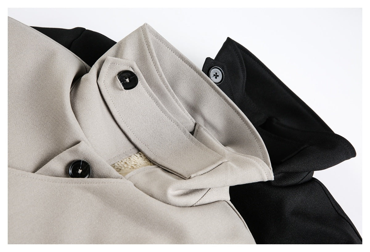 Close-up of beige and black jacket collars with black buttons and a glimpse of plush lining.