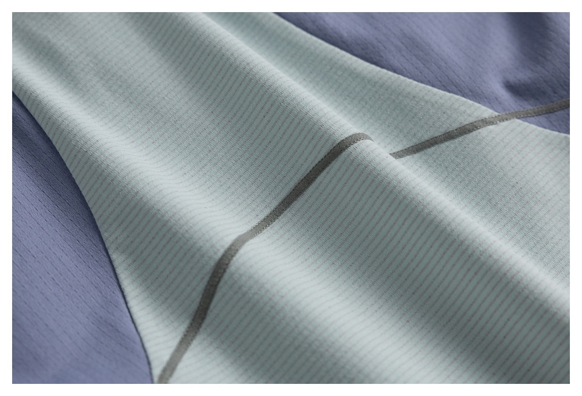 Close-up of pale mint-gray striped fabric with gray seam trim beside a blue-gray panel.