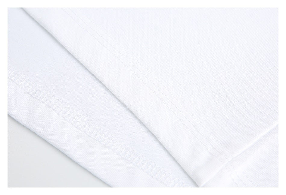 Close-up of the stitched hem and seam on white shirt fabric.