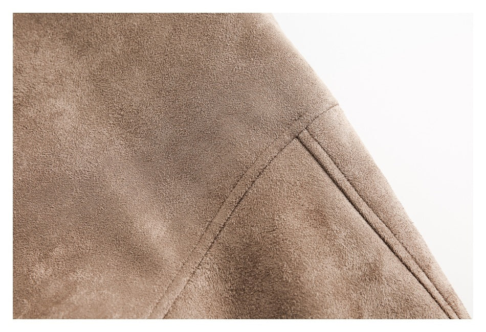 Close-up of a brown jacket panel showing a diagonal seam and narrow welt pocket opening.