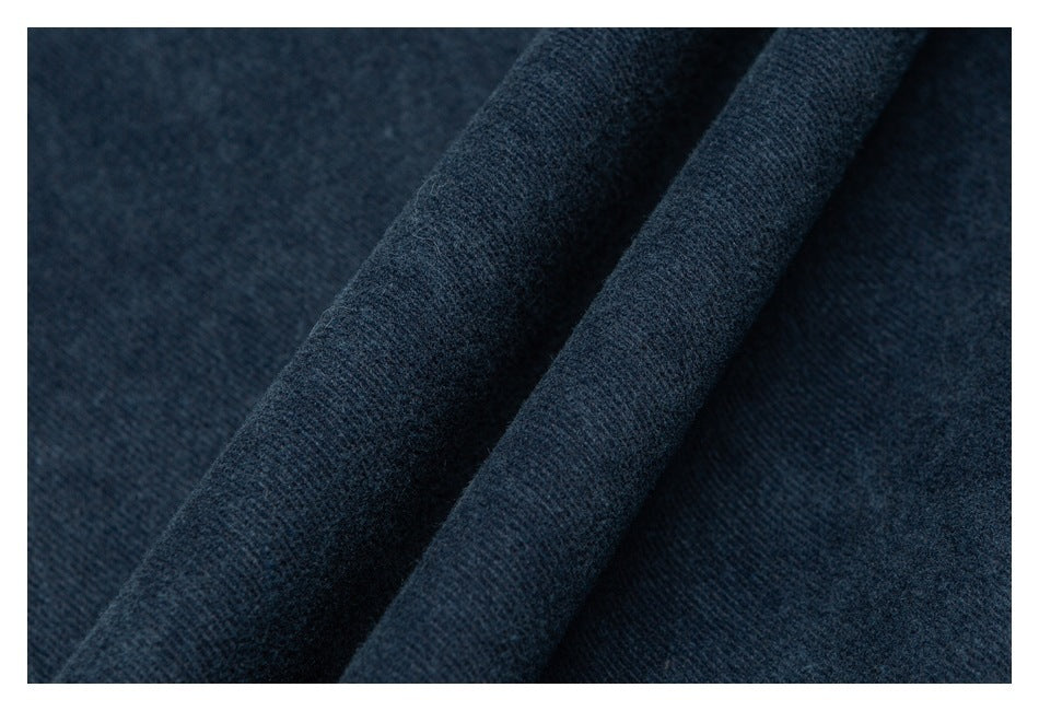 Macro view of dark blue fabric showing its fine, textured weave.
