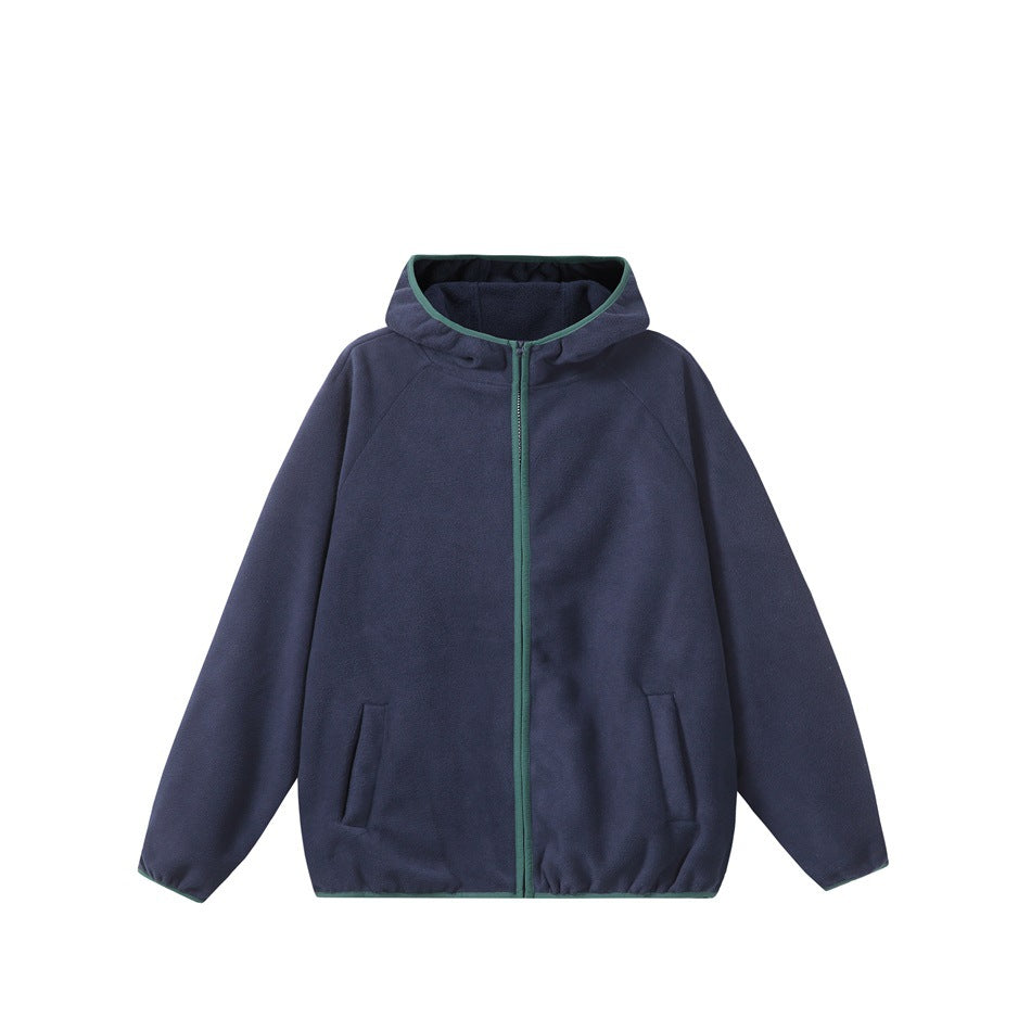 Front view of a navy hooded jacket laid flat, with a green zipper and trim and two front pockets.