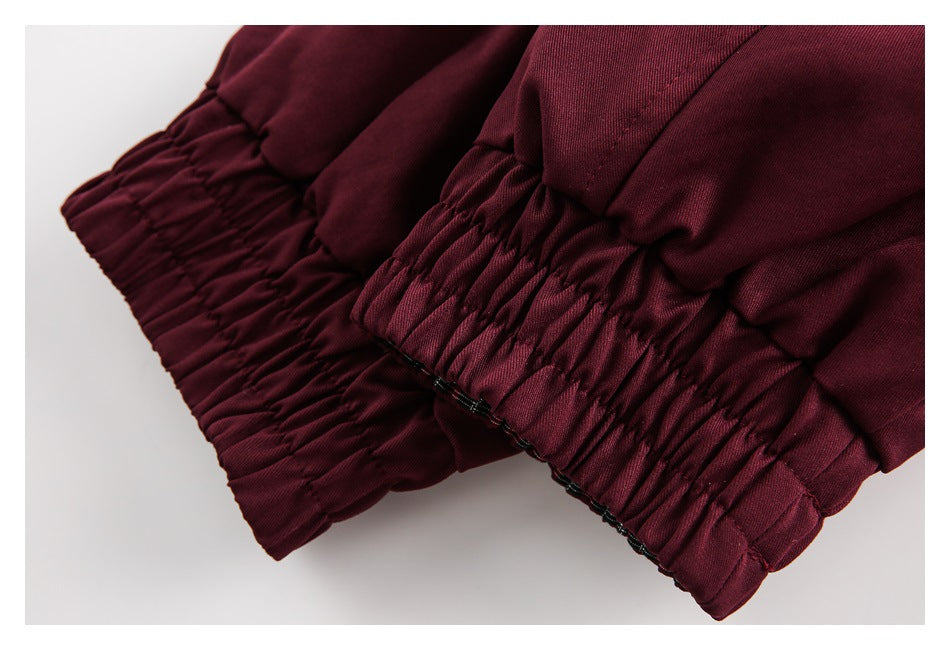 Close-up of the jacket's gathered burgundy cuffs.