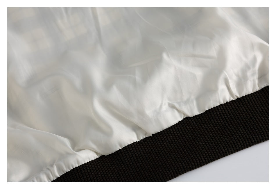 Close-up of the jacket's smooth white lining gathered above a wide black ribbed hem.