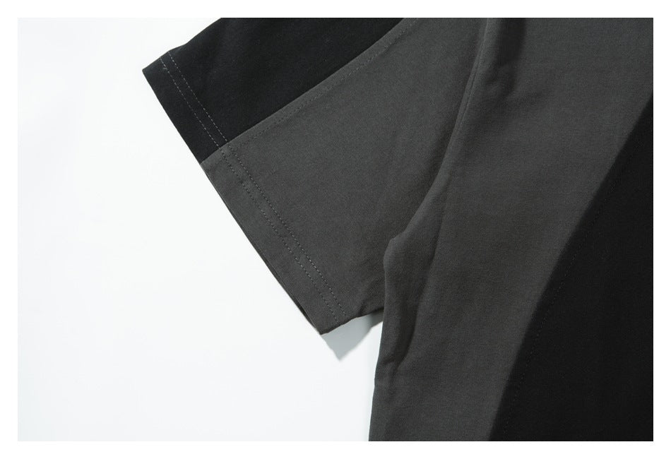 Close-up of a short sleeve showing charcoal and black color-blocking with double-stitched edges.