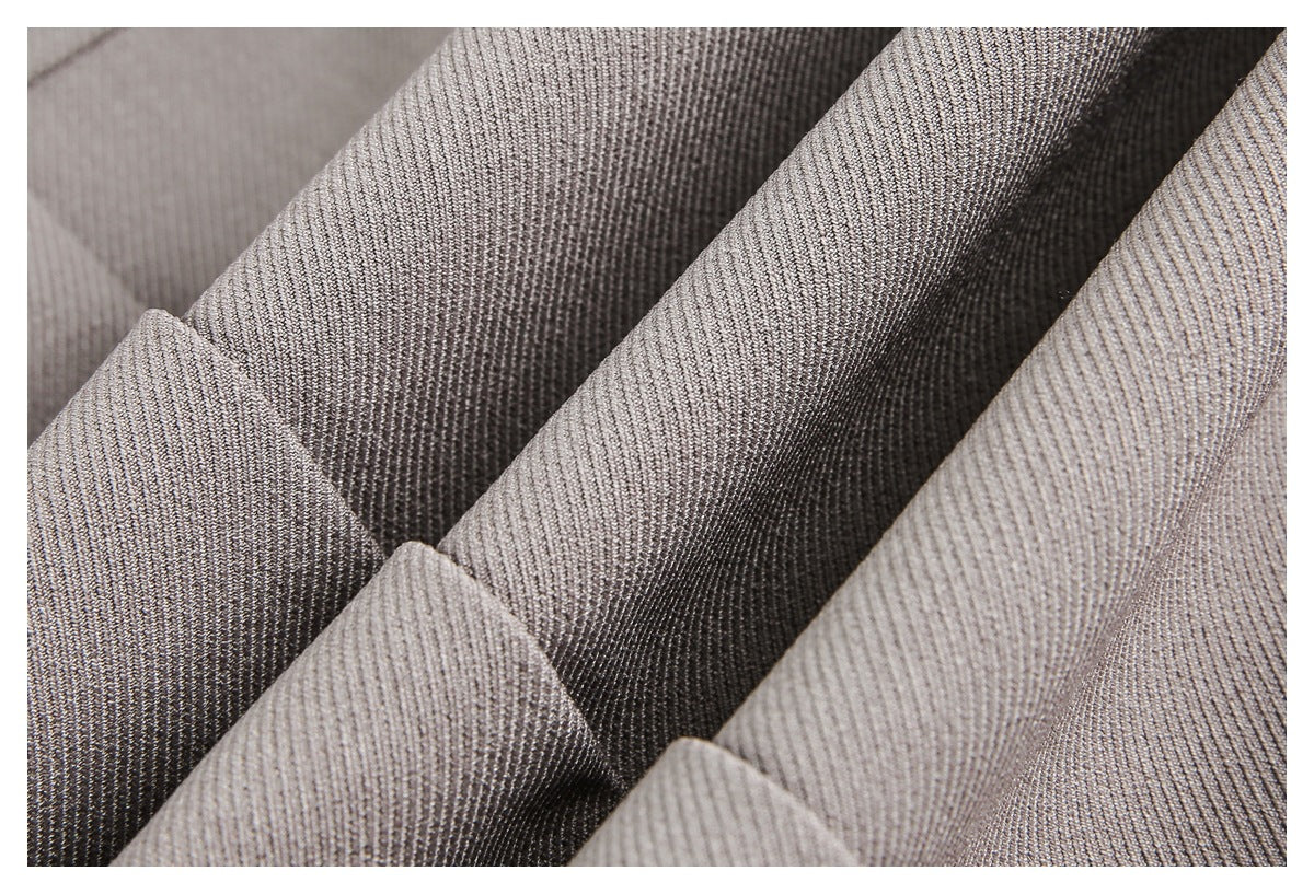 Close-up of taupe fabric arranged in folds, showing its fine textured surface.
