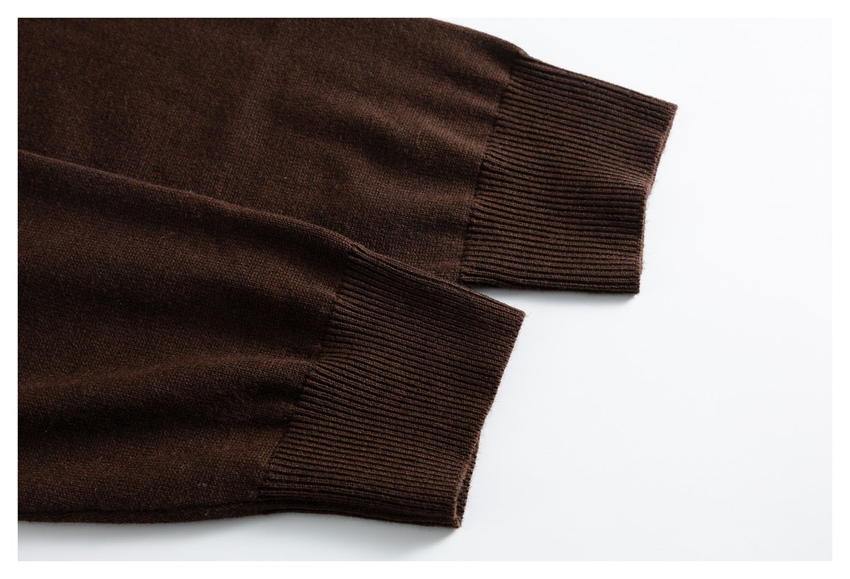 Close-up of the dark brown cardigan's sleeves and wide ribbed cuffs laid flat.