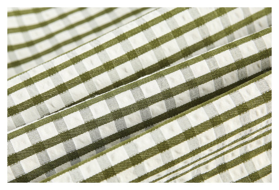 Macro view of olive green and cream checked fabric with raised stripes and woven texture.