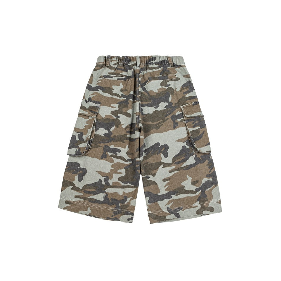 Back of camouflage cargo shorts showing elastic waistband, welt pockets and side cargo pockets on a white background