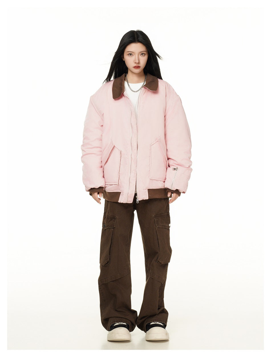 Full-length model wearing a pale pink jacket with a dark brown collar and trim, brown cargo pants and white sneakers.