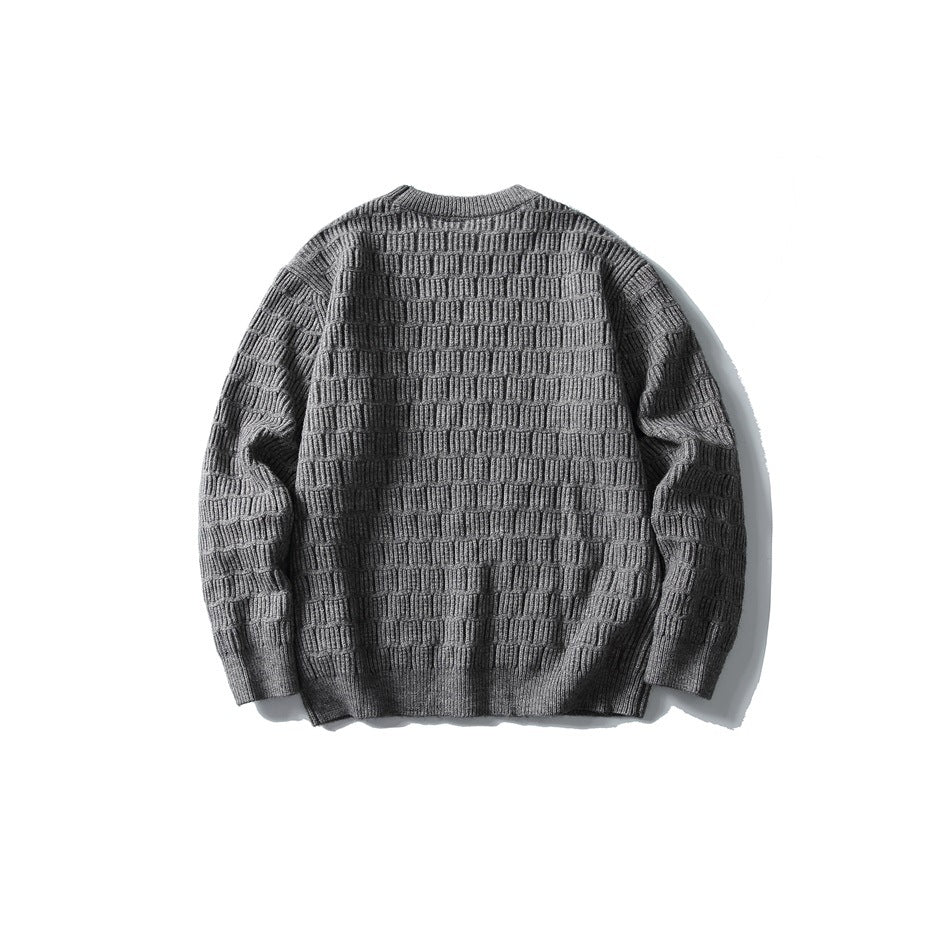 Back view of a charcoal gray crew-neck sweater with raised horizontal block-knit texture and ribbed cuffs and hem.
