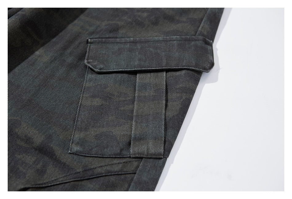 Close-up of a flap cargo pocket on dark camouflage trousers.