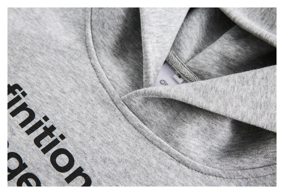 Close-up of a heather-gray sweatshirt neckline with cropped black lettering on the front.