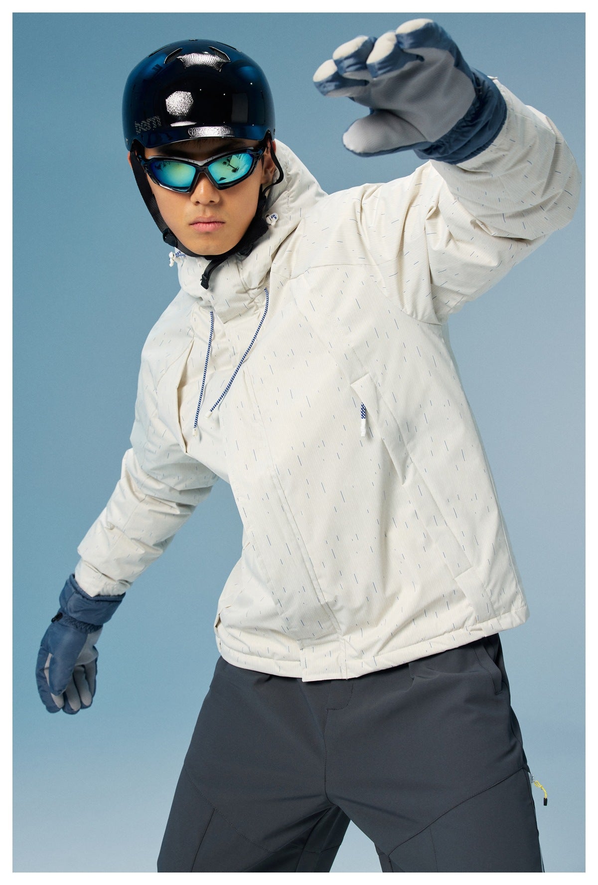 Model in a white subtly striped hooded ski jacket and blue gloves, leaning forward in a dynamic pose.