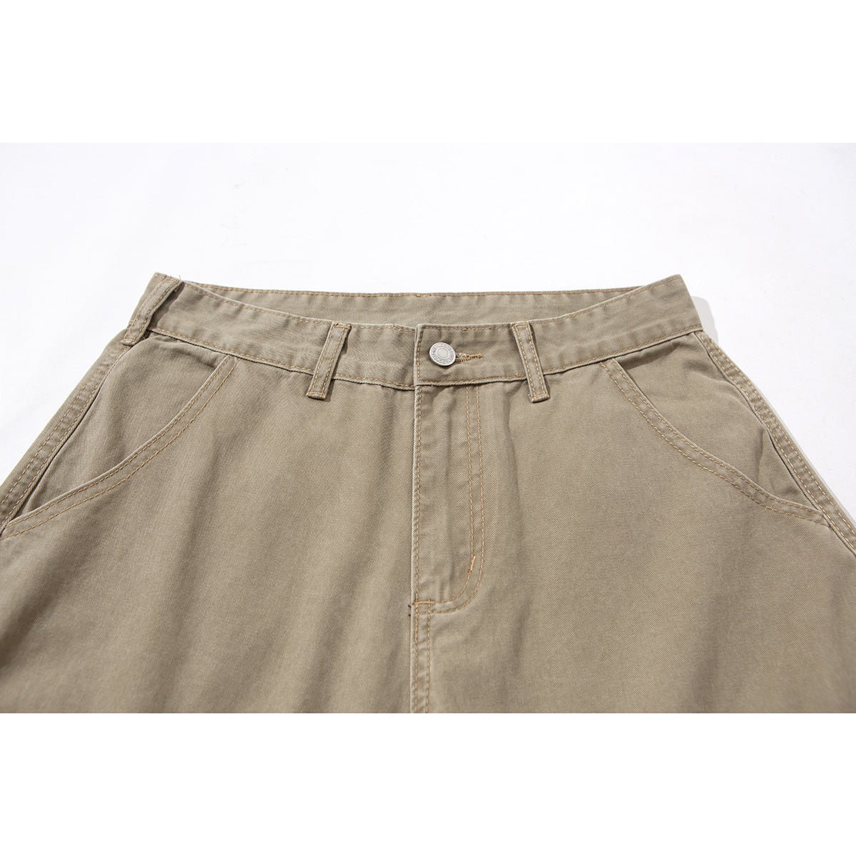 Close-up of taupe cargo pants showing the waistband, button, belt loops, fly stitching, and angled front pockets.