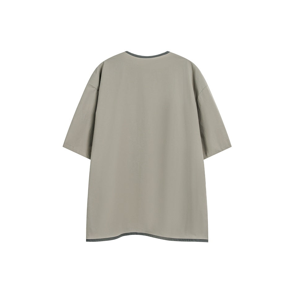 Back view of a plain beige short-sleeve shirt with dark trim at the collar and hem.