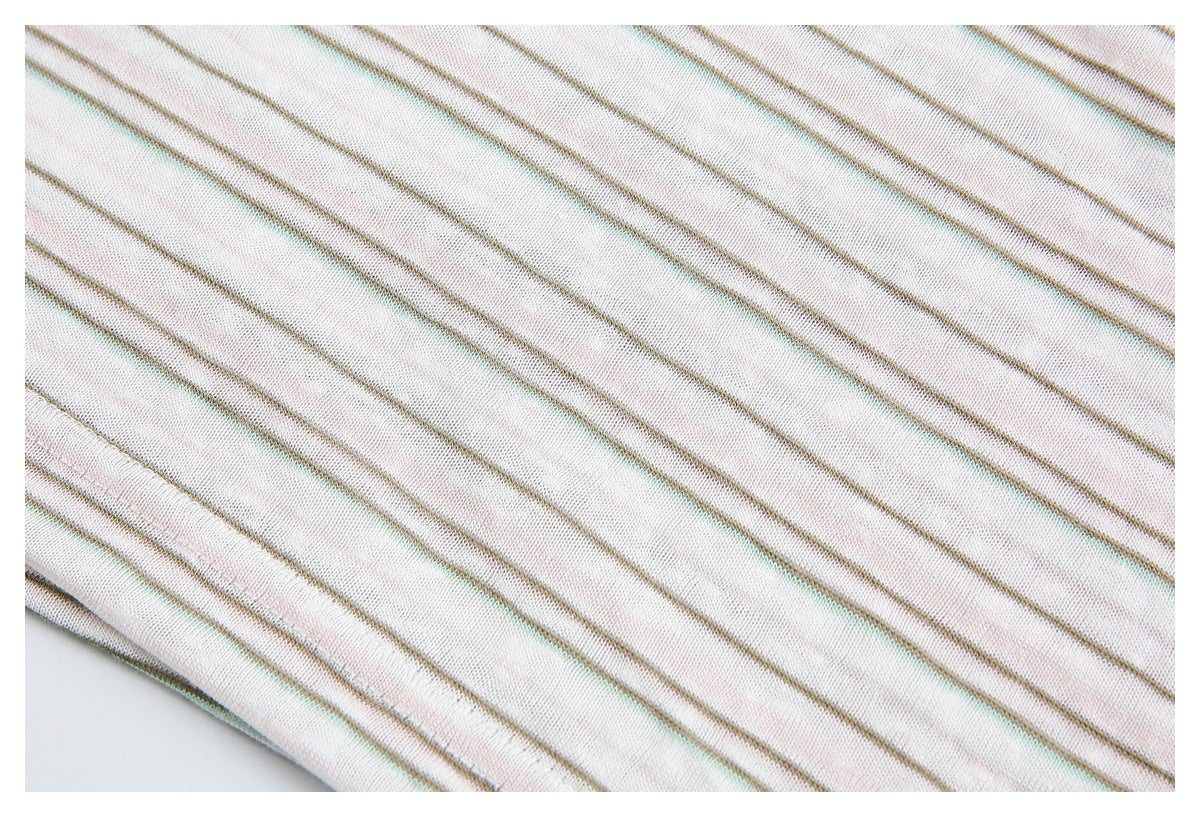 Close-up of off-white knit fabric with thin muted taupe, pale pink, and mint stripes.