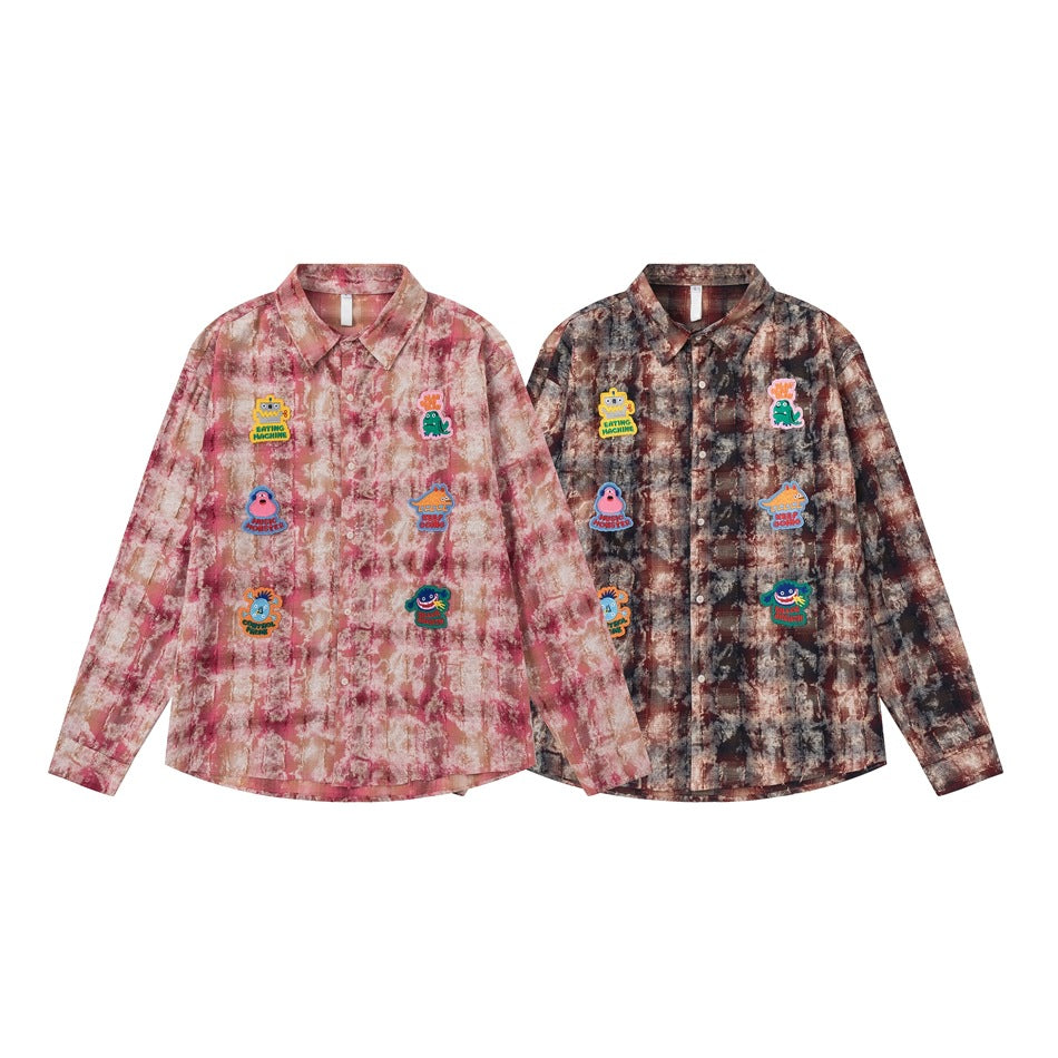 Two button-up shirts displayed side by side: one pink marbled and one dark brown marbled, both with colorful patches.
