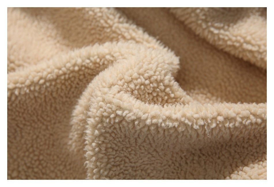 Close-up of the cream, curly fleece lining of a jacket.
