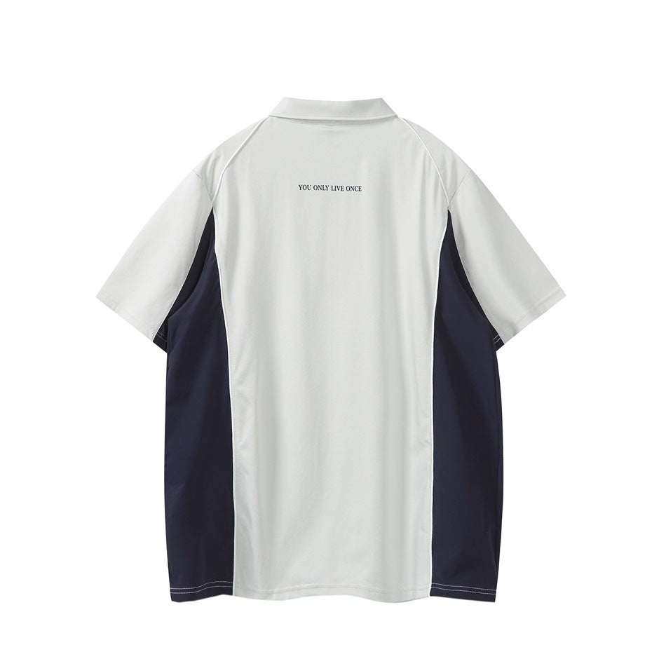 Back view of light gray short-sleeve polo with navy side panels, white piping and small print below the collar