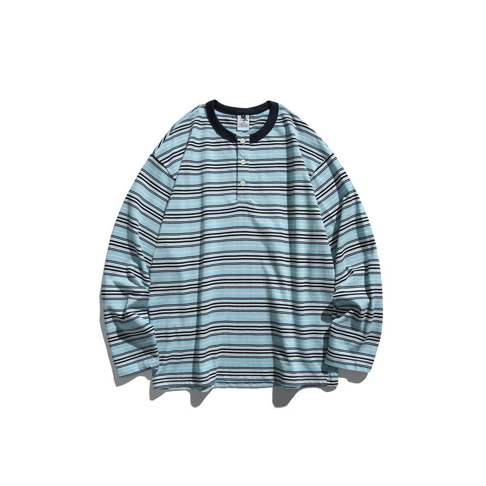 Blue striped long-sleeve top with navy ribbed round neckline and three-button placket, flat lay