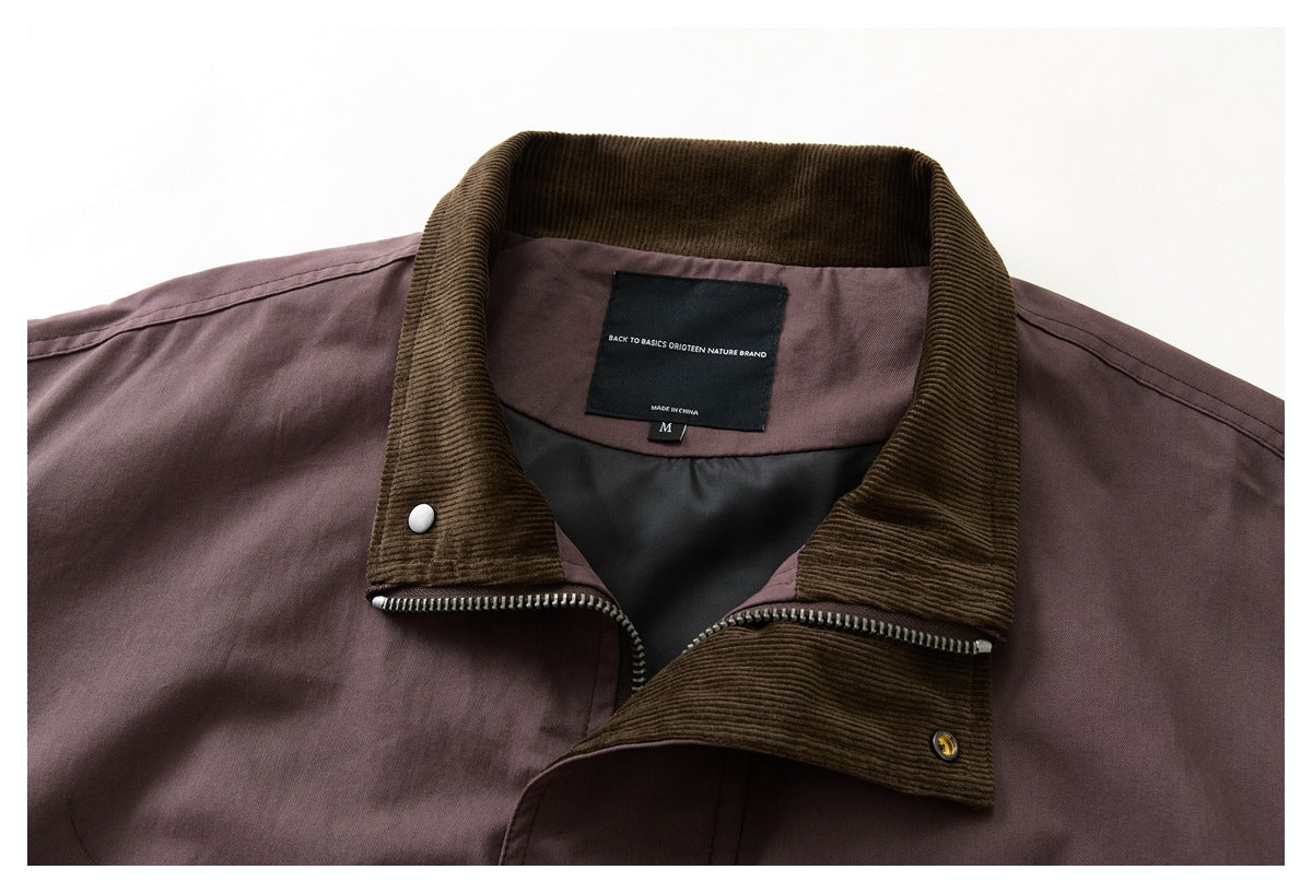 Close-up of a plum jacket's brown corduroy collar, zipper, lining, and sewn neck label.