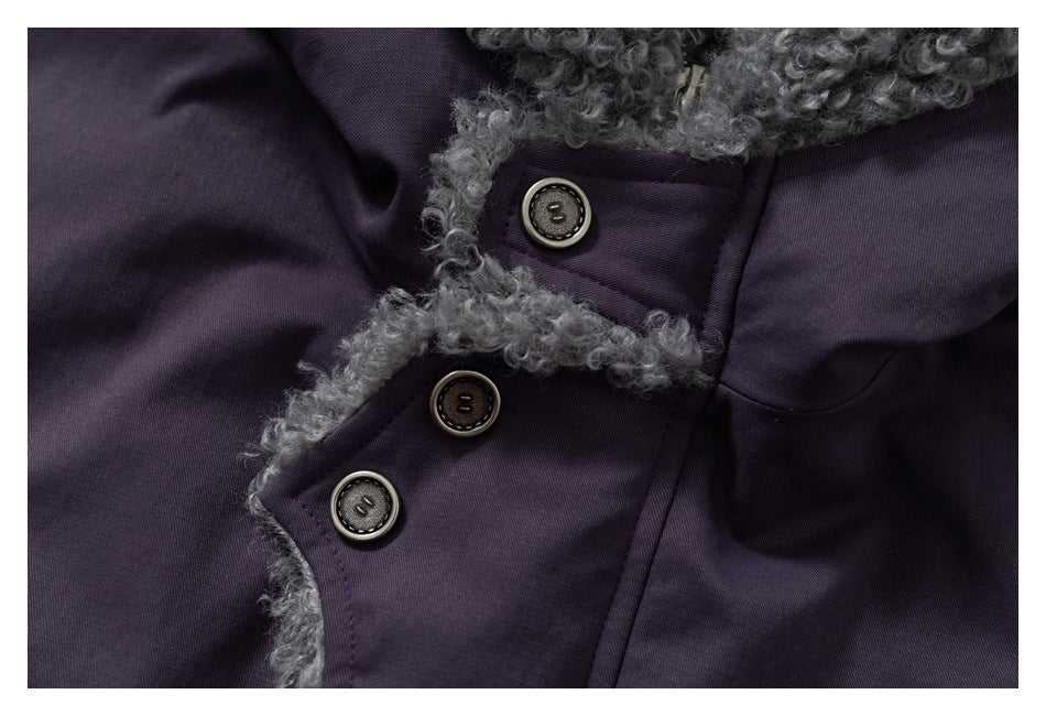 Close-up of a dark purple coat with gray fuzzy trim and three dark buttons.