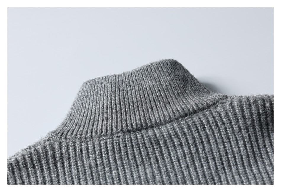 Close-up of the ribbed high collar on a gray knit garment.