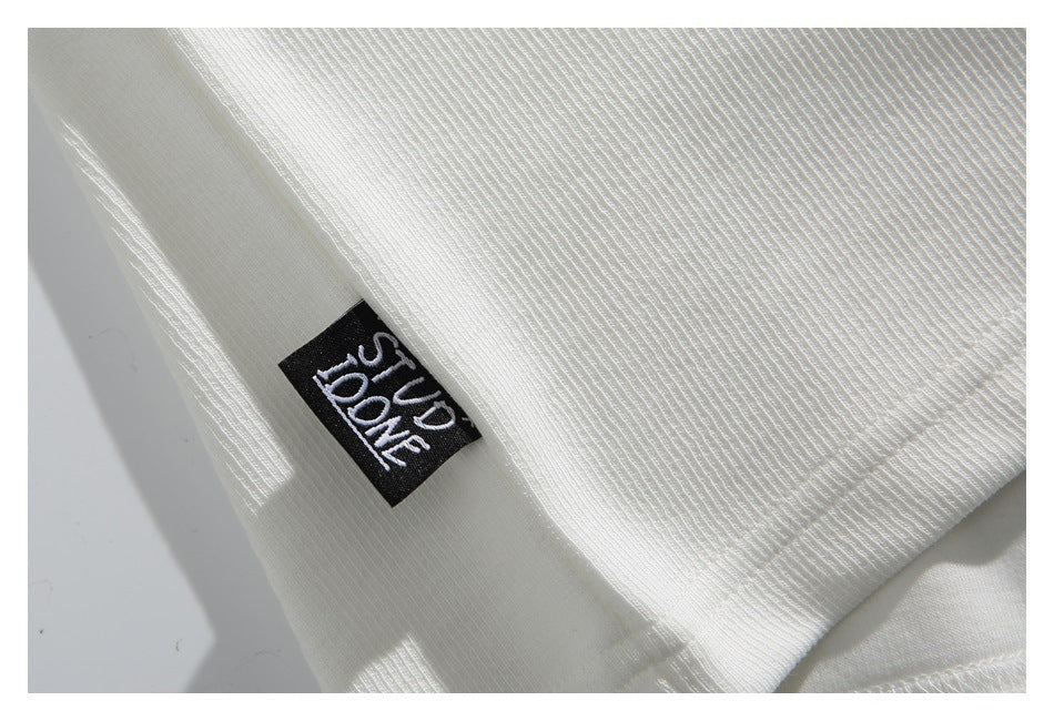 Close-up of the white ribbed fabric and a black sewn-in label with white lettering.