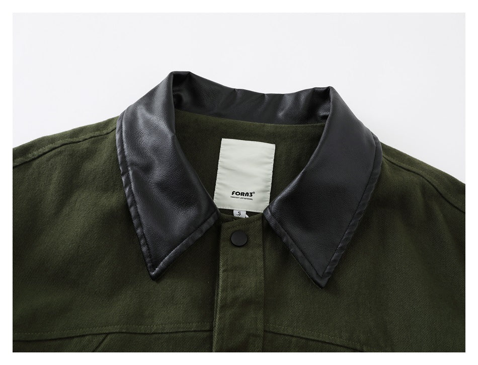 Close-up of an olive jacket neckline with a glossy black collar, snap, and sewn-in brand and size labels.