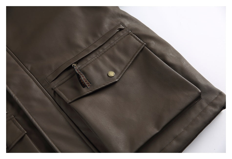 Close-up of a dark brown jacket pocket with a flap, brass-tone button, and patterned zipper pull.