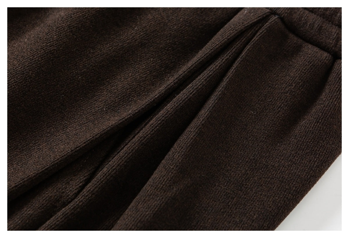 Close-up of dark brown knit fabric gathered in soft folds.