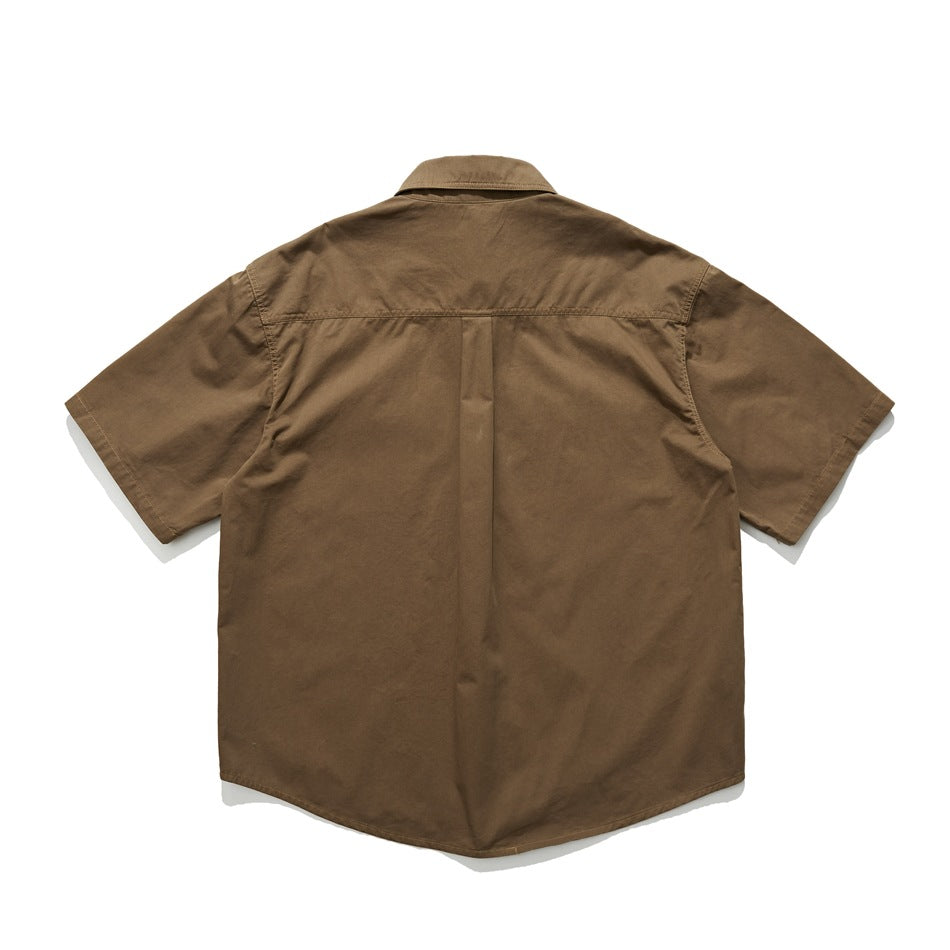 Back view of a brown short-sleeve button-up shirt laid flat against a white background.