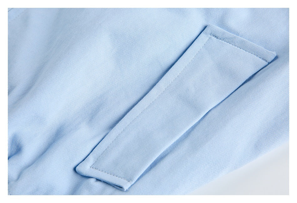 Close-up of a rectangular welt pocket on the light blue jacket.