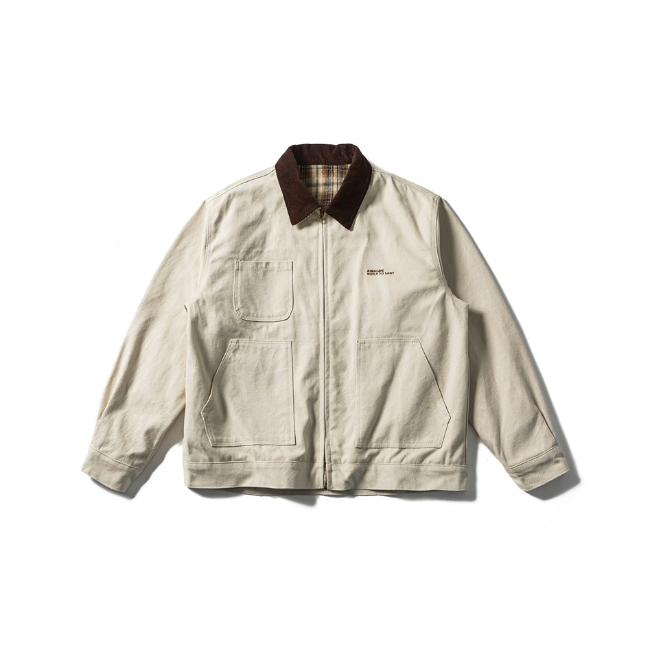 Khaki zip-front work jacket with brown collar, plaid collar underside and three patch pockets, flat lay