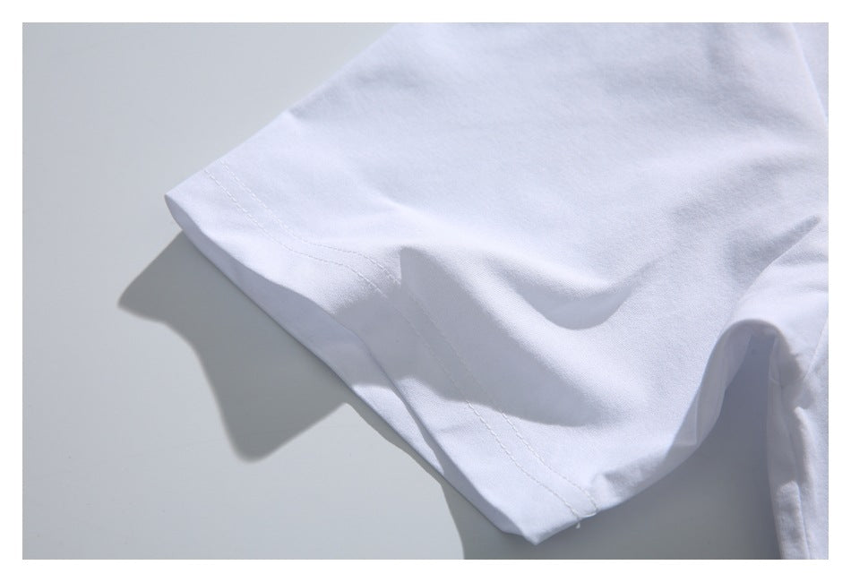 Close-up of the plain white T-shirt sleeve and double-stitched hem.
