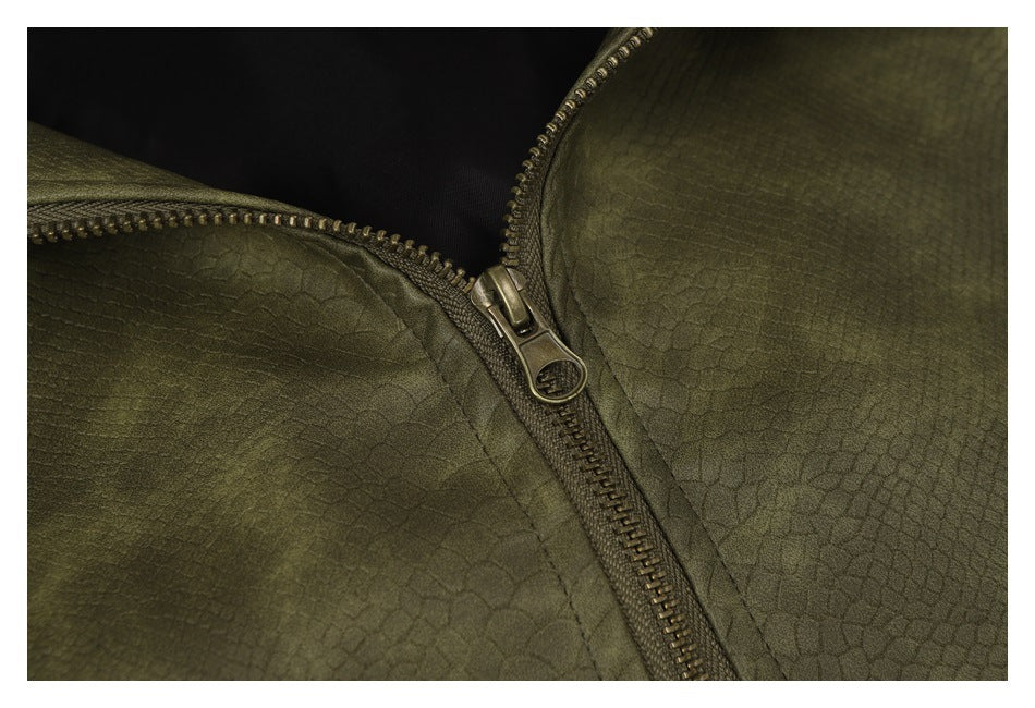 Close-up of the olive jacket’s metal zipper and textured surface.