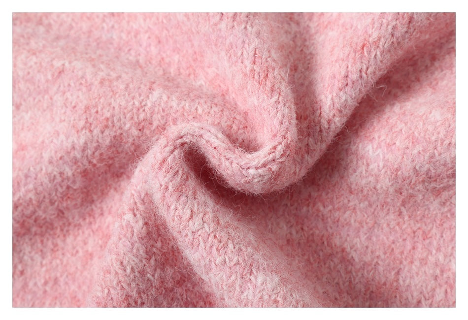 Close-up of fuzzy pink knit fabric gathered into a soft twist.
