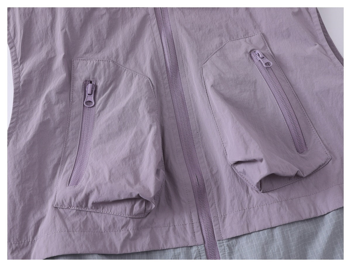 Close-up of two lavender jacket pockets with vertical zippers beside the center front zipper.