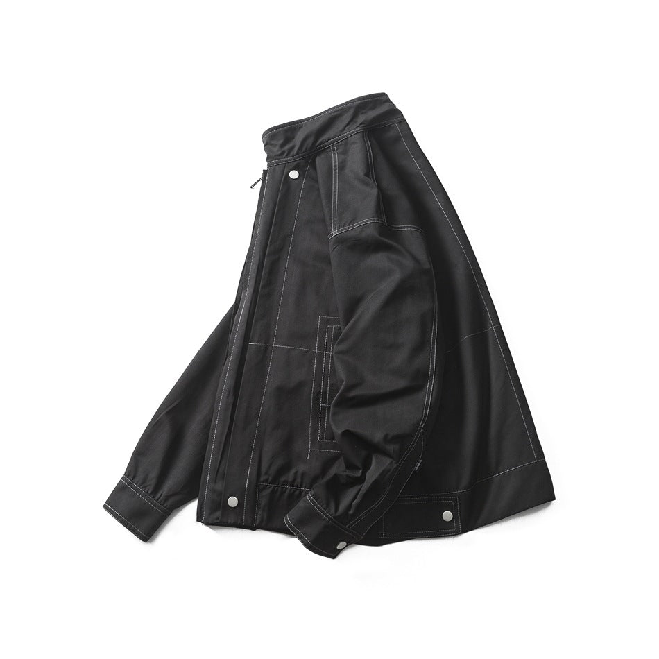 Black jacket shown at an angle, with a stand collar, front zipper, silver snaps and contrast stitching.