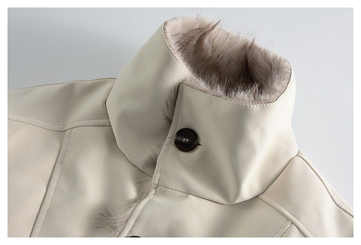 Close-up of the ivory jacket's tall collar, showing plush lining, a dark button, and stitched edges.
