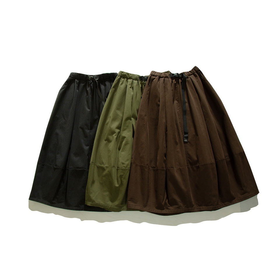 Three flared skirts with gathered waistbands and buckle straps, shown in black, olive green, and brown.