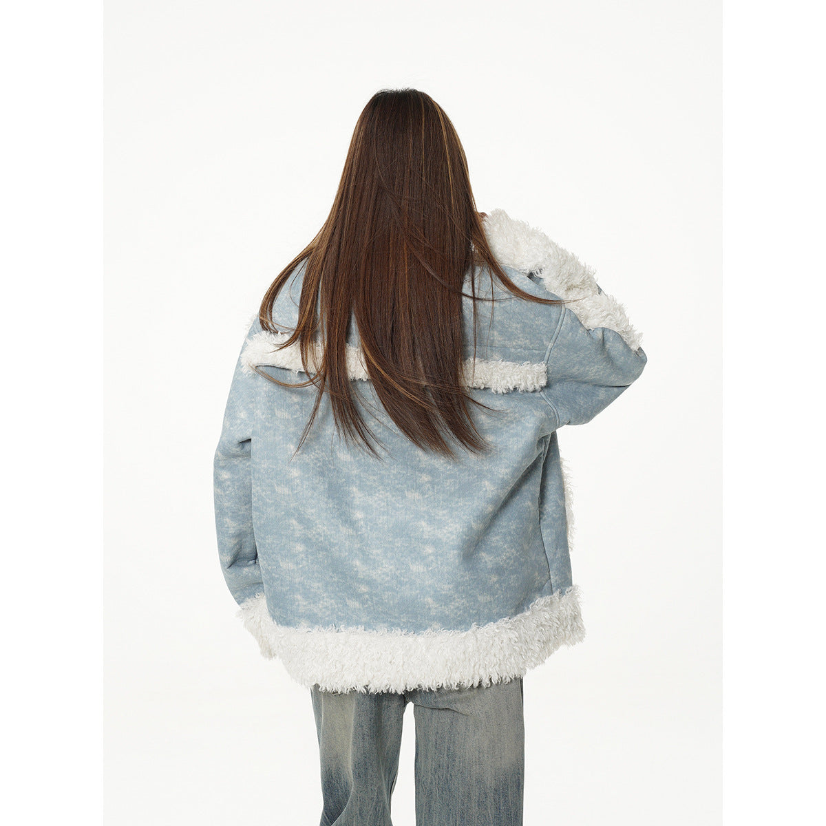 Back view of a model wearing a light blue jacket with white shaggy trim at the shoulders and hem.