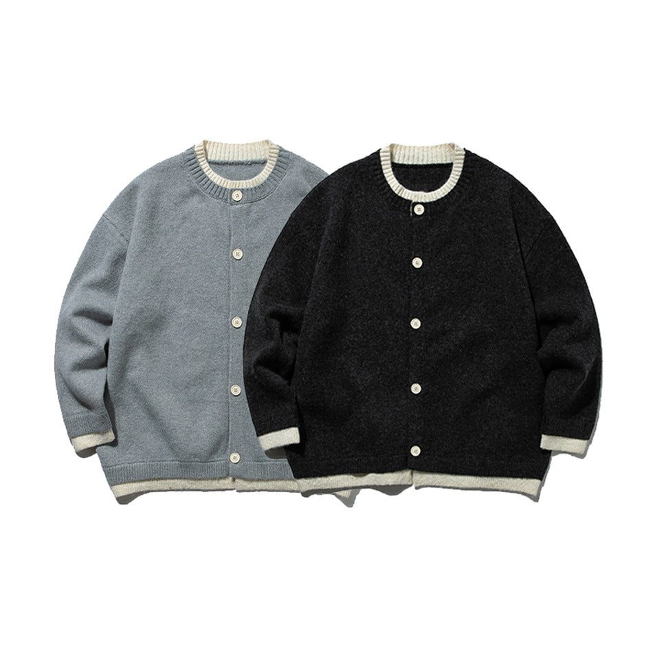 Two button-front knit cardigans shown from the front: one gray and one charcoal, both with cream trim.