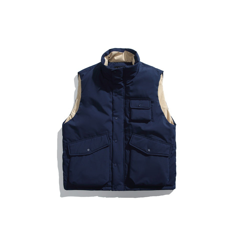 Navy blue padded stand-collar vest, closed front with snap flap pockets and tan lining at collar and armholes
