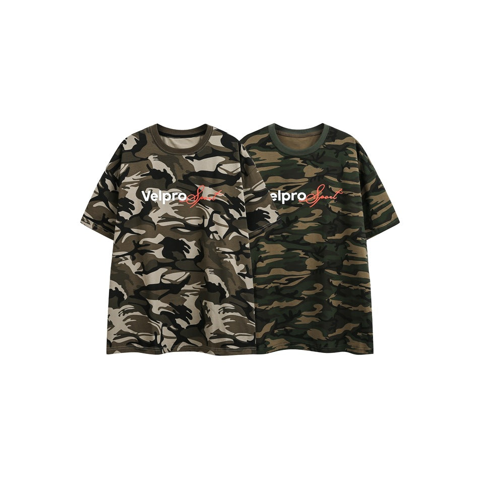 Two short-sleeve camouflage graphic T-shirts displayed side by side in gray-brown and dark green colorways.