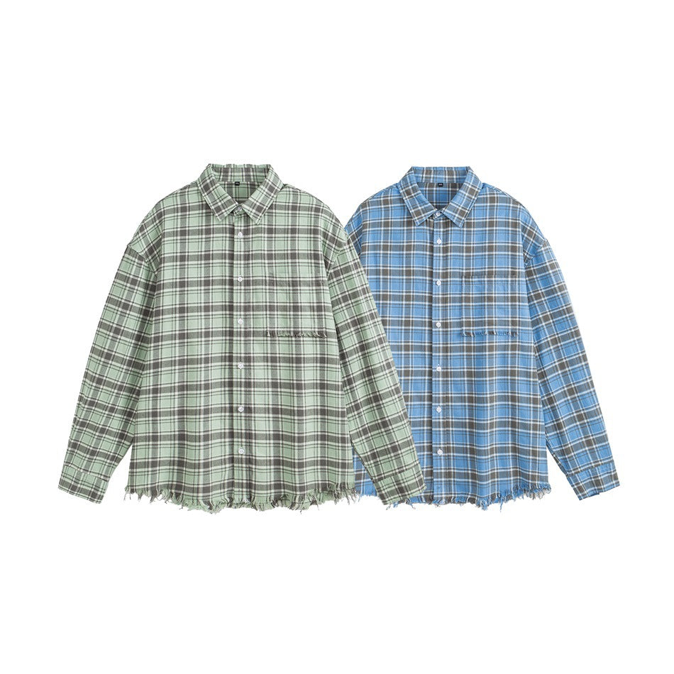 Two oversized plaid button-up shirts shown side by side in sage green and blue, each with a chest pocket and frayed hem.